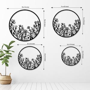 May include: Set of four black metal wall decor pieces in the shape of circles with floral designs. The circles are 36 inches, 30 inches, 24 inches, and 18 inches in diameter.