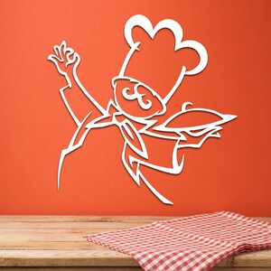 May include: A white wall decal featuring a stylized line art illustration of a chef wearing a tall toque hat and a neckerchief. The chef is depicted with one hand raised in a gesture and the other hand holding a covered serving platter.