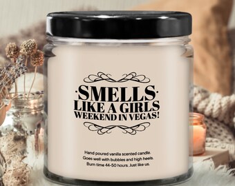 May include: A vanilla scented candle in a glass jar with a black lid. The candle has a black and white label that says "Smells Like A Girls Weekend In Vegas!"  Hand poured vanilla scented candle. Goes well with bubbles and high heels. Burn time 44-50 hours. Just like us.