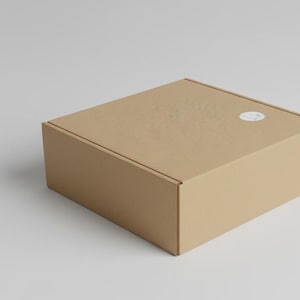 Gift box for a wool blanket, craft cardboard with a logo sticker.