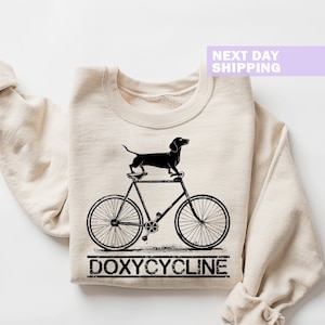 Sudadera con juego de palabras sobre farmacia con doxiciclina, camiseta de farmacéutico con perro salchicha en bicicleta, sudadera con capucha para técnicos farmacéuticos veterinarios, sudadera con capucha para farmacia