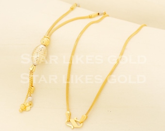 May include: A gold chain necklace with a decorative pendant. The pendant is a gold oval with a textured surface. The chain is a delicate, fine chain.