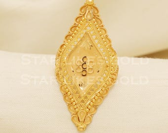 May include: A gold-colored ring with an elongated, diamond-shaped design. The ring features intricate filigree and beaded detailing around the edges. The center has a textured pattern with the text "STAR 1655 GOLD".