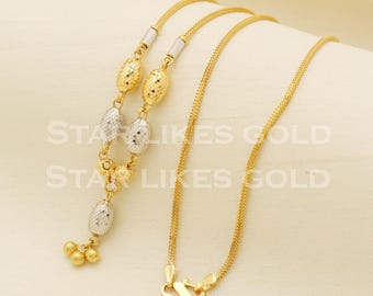 May include: A gold chain necklace with a pendant featuring alternating gold and silver oval beads. The pendant has three small gold balls at the bottom.