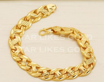 May include: A gold chain bracelet with a textured, intricate design. The bracelet has a clasp closure.