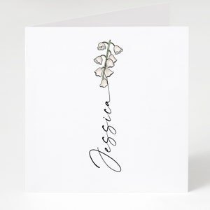 May include: A white card with a simple line drawing of a lily of the valley flower and the name "Jessica" written in cursive.