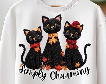 Pode incluir: Camisola branca com um desenho de três gatos pretos adornados com folhas de outono laranja e vermelhas e acessórios. Os gatos usam cachecóis e chapéus. O texto "Simply Charming" está em baixo. A camisola tem gola redonda.