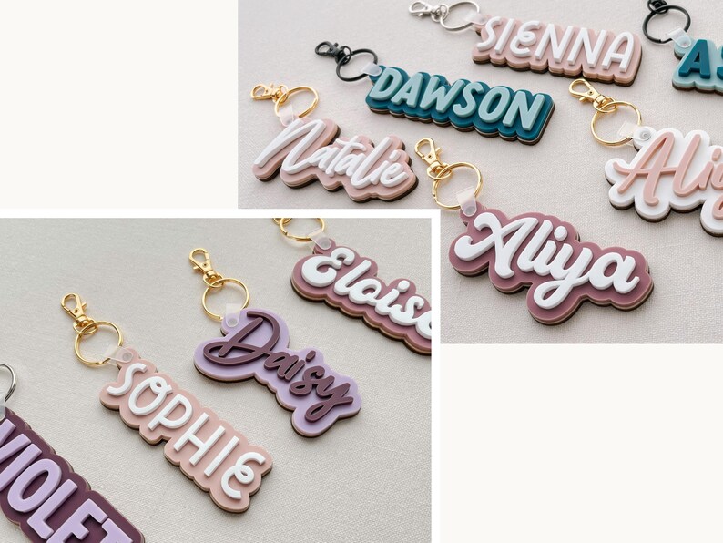 Puede incluir: Una colecci&oacute;n de llaveros personalizados con nombres en varios colores. Cada llavero presenta un nombre en un dise&ntilde;o en capas con una capa superior blanca, sujeto a un llavero de metal. Los nombres incluyen Sienna, Dawson, Natalie y otros.