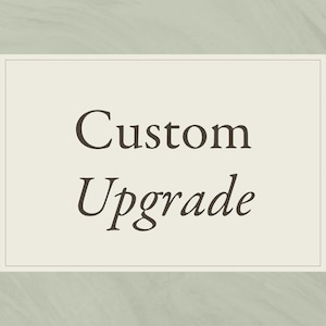 May include: A rectangular graphic featuring a light cream-colored background with a thin border. The text Custom Upgrade is centered in the middle in a dark brown serif font. The overall design is clean and simple with a subtle marbled texture.