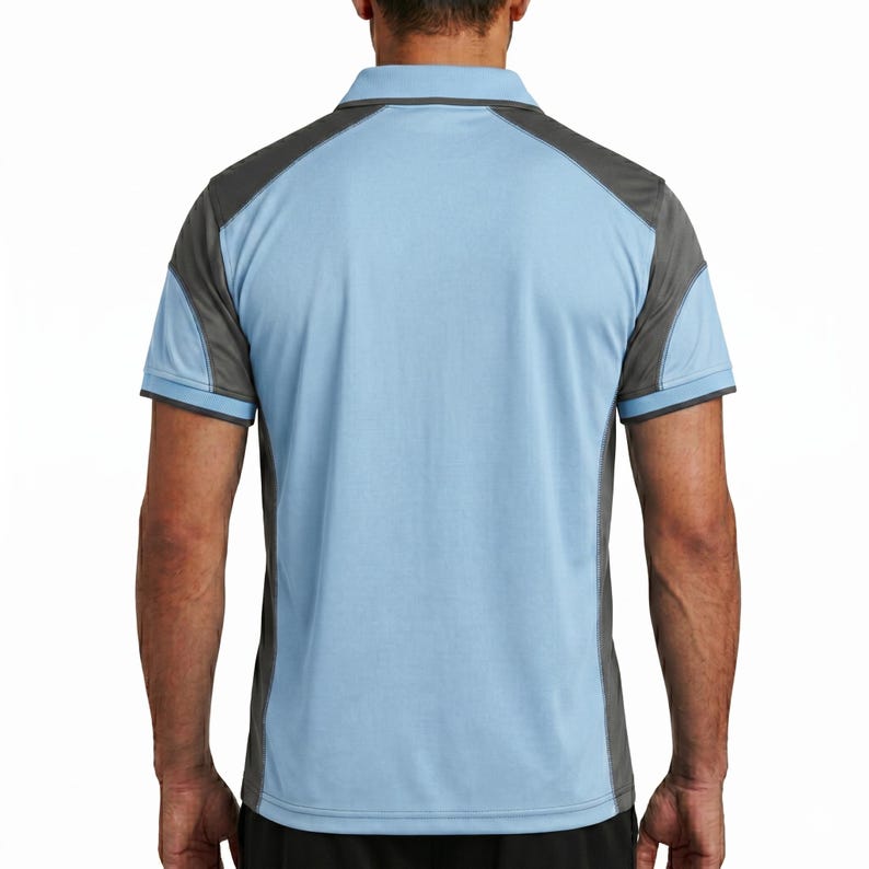 May include: A short-sleeved polo shirt featuring a light blue main body with dark gray panels on the shoulders and sides. The garment has a classic collar, a buttoned placket, and short sleeves with dark gray trim along the edges of the cuffs.