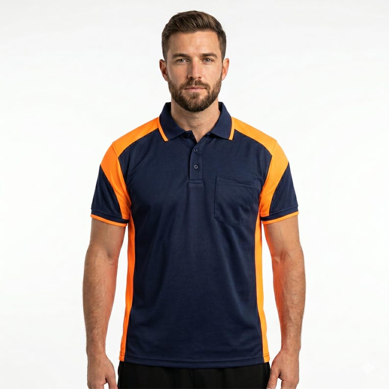 May include: A short-sleeved polo shirt featuring a dark navy blue main body with bright orange panels on the shoulders and sides. The shirt includes a classic collar, a three-button placket, and a single chest pocket on the left side.