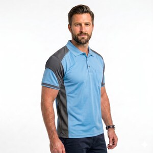 May include: A short-sleeved polo shirt featuring a light blue main body with dark gray side panels and shoulder accents. The shirt includes a classic collar, a buttoned placket, and a single chest pocket on the left side, paired with dark trousers.