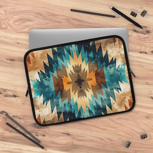 May include: A laptop sleeve with a geometric pattern in shades of blue, brown, and yellow. The pattern resembles a Native American rug or blanket.