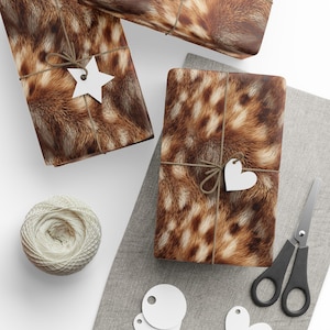May include: Gift-wrapped presents with a brown and tan animal fur pattern. Each package is tied with twine and a white tag. A ball of twine, scissors, and blank tags are also visible.