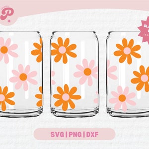 May include: Three glass can wraps with a retro floral design. The design features orange and pink flowers with white outlines on a clear background. The wraps are for 16oz and 20oz cans.  "GLASS CAN WRAP 16oz & 20oz" is printed on a pink star.
