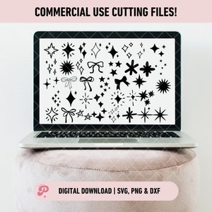 May include: A laptop screen displaying a collection of black and white illustrations of stars, sparkles, and bows. The text "COMMERCIAL USE CUTTING FILES!" is at the top of the screen. The laptop is sitting on a pink surface. The text "DIGITAL DOWNLOAD | SVG, PNG & DXF" is at the bottom of the image.