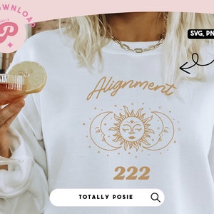 May include: White sweatshirt with a gold sun and moon design and the text "Alignment 222".