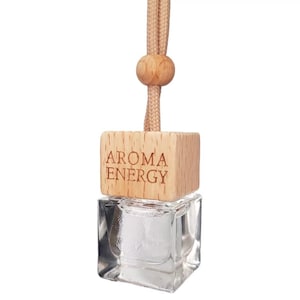 May include: A wooden car air freshener with a clear glass bottle and a string for hanging. The wooden block has the text "Aroma Energy" engraved on it.