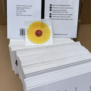May include: A stack of white packaging for 4-pack fly trap window stickers. The packaging features a sunflower design and the text "FIXMAN Hardware & Fixings 4pk Fly Trap Window Sticker".