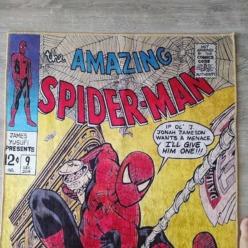 May include: A vintage comic book cover featuring Spider-Man in a red and blue suit, swinging from a building with a yellow background. The cover text reads "The Amazing Spider-Man" and "If ol' J. Jonah Jameson wants a menace, I'll give him one!!!".