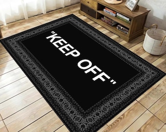 May include: Black and white rug with a decorative border and the text "KEEP OFF" in white letters.