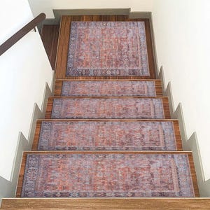 May include: A set of five stair treads with a vintage floral pattern in shades of pink, blue, and gray. The treads are designed to add a touch of elegance and prevent slipping on stairs.