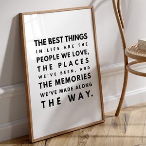 May include: A framed print with a white background and black text that reads "The best things in life are the people we love, the places we've been, and the memories we've made along the way."