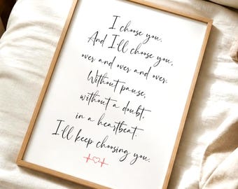 May include: A rectangular wooden frame containing a white print with black cursive text that reads: I choose you. And I'll choose you, over and over and over. Without pause, without a doubt, in a heartbeat. I'll keep choosing you. A small red heart icon with an EKG line is at the bottom.