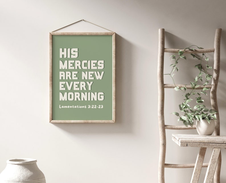 May include: A framed print with a green background and white text that reads "His mercies are new every morning" with the scripture reference "Lamentations 3:22-23" below the text.