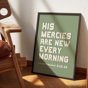 May include: A framed print with a green background and white text that reads "His mercies are new every morning" with the scripture reference "Lamentations 3:22-23" below the text.