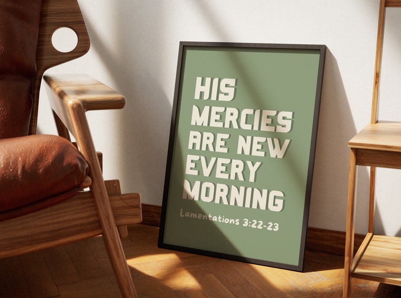 May include: A framed print with a green background and white text that reads "His mercies are new every morning" with the scripture reference "Lamentations 3:22-23" below the text.