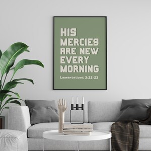 May include: A sage green framed print with the text "His mercies are new every morning" and the scripture reference "Lamentations 3:22-23".