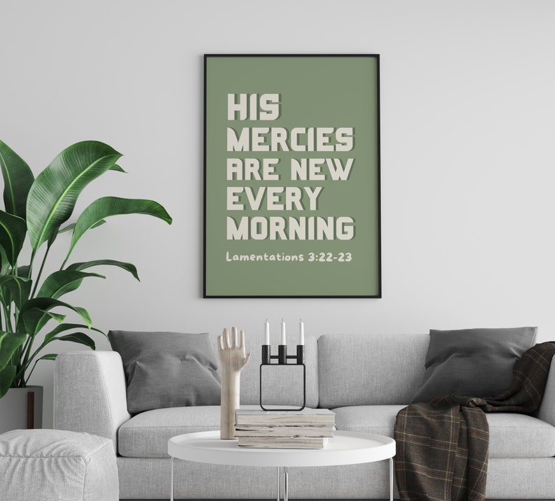 May include: A sage green framed print with the text "His mercies are new every morning" and the scripture reference "Lamentations 3:22-23".