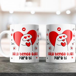 May include: Two white ceramic mugs with red hearts and a cartoon character with hearts for eyes. The text on the mugs reads "solo tengo ojos para ti" which translates to "I only have eyes for you".