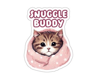 May include: A cute cartoon cat with brown and white fur is peeking out of a pink blanket with white stars. The text "Snuggle Buddy" is above the cat.