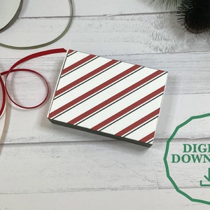 May include: A printable digital download of a red and white striped gift box design. The design is perfect for wrapping gifts for the holidays.