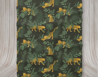 May include: A dark green fabric with a repeating pattern of yellow leopards and green leaves. The leopards are in various poses, some are lying down, some are standing, and some are walking.