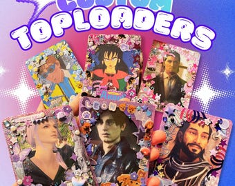 May include: A hand holding six custom top loaders, each decorated with images and embellishments. The top loaders feature various characters and are adorned with stickers, gems, and other decorative elements. The text "CUSTOM TOPLOADERS" is at the top.