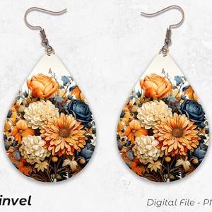 May include: A pair of teardrop-shaped earrings with a floral design. The earrings feature a bouquet of orange, yellow, white, and blue flowers on a white background.