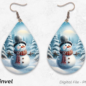 May include: A pair of dangle earrings featuring a winter scene with a snowman in a red and white scarf standing in a snowy forest. The earrings are made of metal and have a teardrop shape.