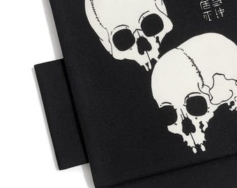 May include: Black fabric with a white skull print. The design features two skulls and Japanese text. The product is from the brand "Another Date Night".