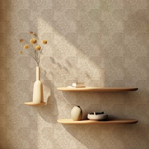 Può includere: Due mensole in legno con bordi arrotondati sono montate su una parete beige con un motivo floreale. Un vaso con fiori secchi si trova sullo scaffale superiore, e un vaso e una ciotola sono sullo scaffale inferiore.