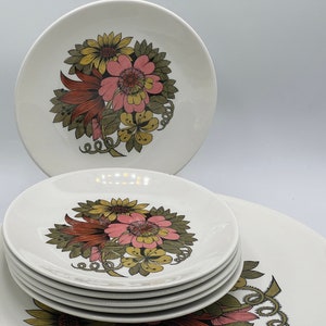 以下が含まれることがあります： 白いセラミックプレートのセットで、花の模様が施されています。 ピンク、黄色、茶色の花と緑の葉が特徴です。 セットには、ディナープレートと小さなプレートが含まれています。