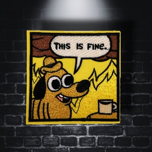 May include: A yellow embroidered patch featuring a cartoon dog wearing a hat, sitting in a burning house, with the text "This is fine." The dog has large eyes and a smile.