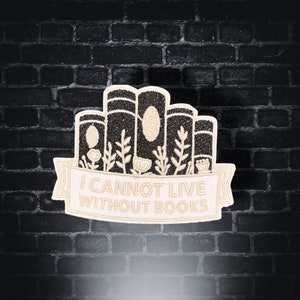 May include: A beige embroidered patch with a stack of books, flowers, and the text "I cannot live without books".