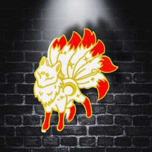 May include: Embroidered patch of a white fox with nine red-tipped tails and gold detailing. The patch is set against a dark brick wall. Suitable for clothing or accessories.