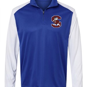 May include: A blue and white long-sleeve athletic shirt with a red and white mascot logo on the chest. The logo features a bulldog wearing a cap and holding a football. The logo says "SC" above the bulldog.