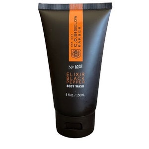 May include: A black plastic bottle of body wash with an orange label. The label says "C.O. Bigelow Barber Est. 1838" and "No. 0237 Elixir Black Pepper Body Wash 5 fl.oz. / 150ml".