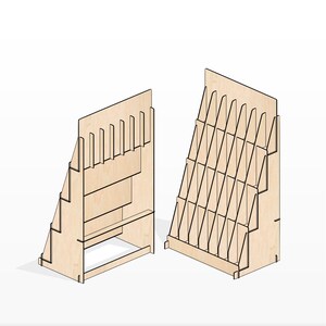 May include: Two wooden magazine display stands. The stand on the left has a single shelf and a back panel with slots for magazines. The stand on the right has multiple shelves and a back panel with slots for magazines.