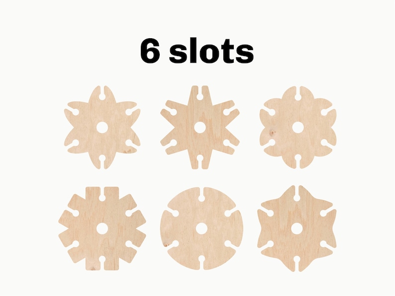 May include: Six wooden discs with different patterns, each with six slots around the edge. The text "6 slots" is printed above the discs.